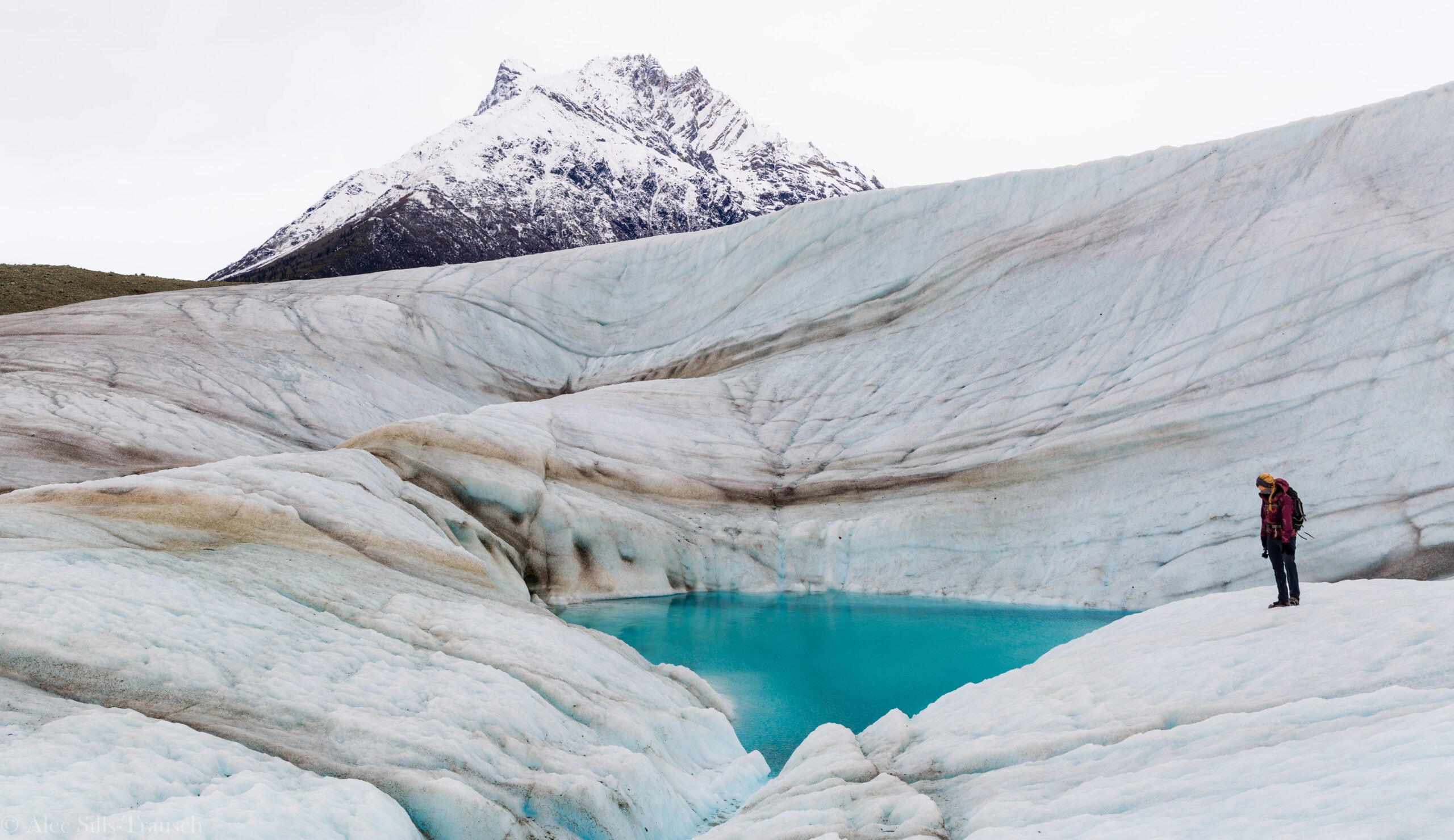 A majestic glacier in Alaska with a small cruise ship in the foreground
